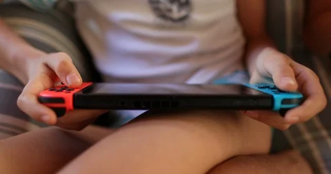 Closeup of child hands playing video game on joystick controller Stock Footage 125937558