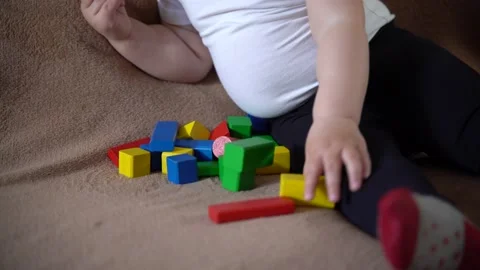 Closeup children's hands playing colored wooden cubes Stock Footage 237608167