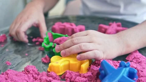 Closeup of child's hands playing in kinetic sand Stockbeeldmateriaal 161143756