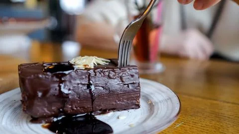 Closeup Chocolate Cake Slice At Cafe, Fork Cutting Rich Ganache, Syrup Pooling Stock Photos