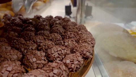 Closeup of a chocolate fudge ball with a server in the background. Stock Footage 328523287