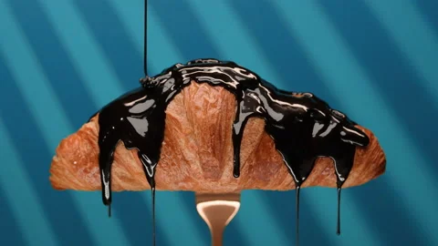 Closeup chocolate sauce pouring on fresh croissant, sweet and natural product Stock Footage 155270989