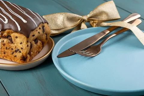 Closeup of Chocotone with chocolate coating next to cutlery, ribbon bow and.. Stock Photos