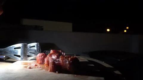 Closeup of chorizo chunks steaming on a table and grabbing with hands to eat at Stockbeeldmateriaal 155793530