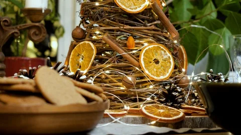 Closeup of a Christmas tree made of vine, cinnamon, anise, nuts and oranges. 4K Stock Footage 122248600
