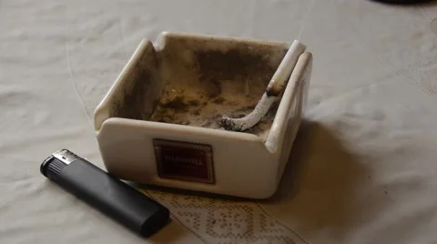Closeup of cigarette on ashtray with a beautiful wisp of smoke Stock Footage 48374342