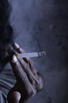 Closeup of cigarette butt with hand Stock Photos