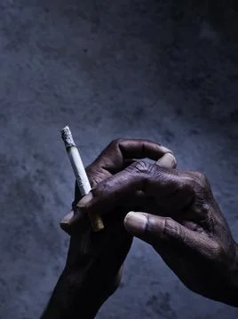 Closeup of cigarette butt with hand Stock Photos