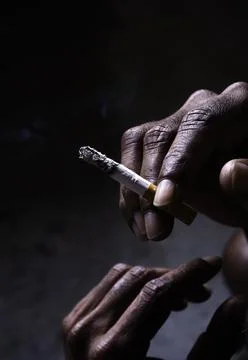 Closeup of cigarette butt with hand Stock Photos