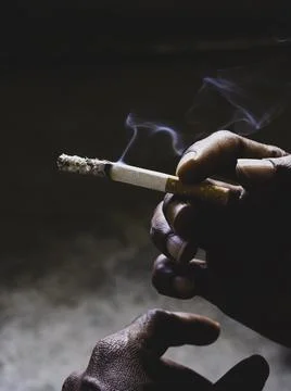 Closeup of cigarette butt with hand Stock Photos