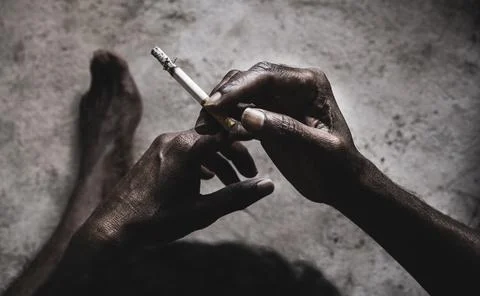 Closeup of cigarette butt with hand Stock Photos