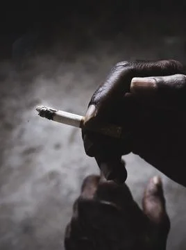 Closeup of cigarette butt with hand Stock Photos