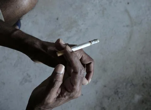 Closeup of cigarette butt with hand Stock Photos