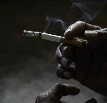 Closeup of cigarette butt with hand Stock Photos