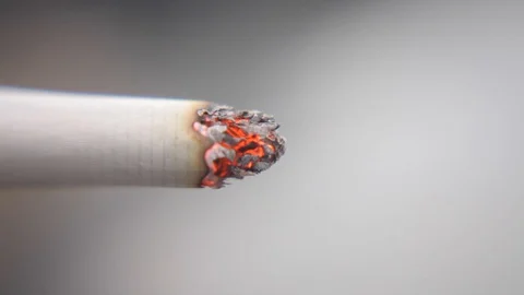 Closeup of cigarette cherry flaming as being inhaled by consumer Видео 128747663