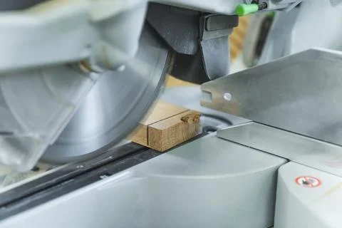 Closeup circular saw machine cutting wooden board Photos