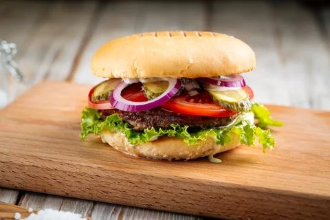 Closeup on classic hamburger with beef patty Stock Photos