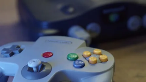 Closeup Of Classic Nintendo 64 Console With Controller In Foreground. rack focus Stock Footage 311682012