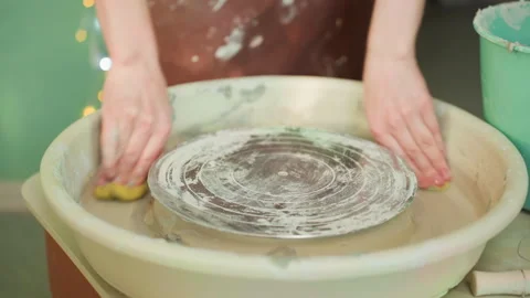 Closeup of clay sponge cleaning. Caucasian hands carefully cleaning wet clay Stock Footage 342283336