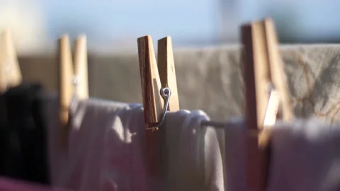 Closeup on clean laundry drying on a wire, gently moved by the wind, housewor Video stock 136782108