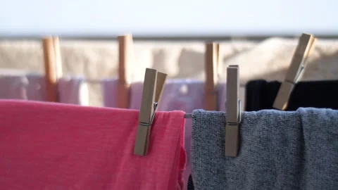 Closeup on clean laundry drying on a wire, gently moved by the wind, housework c Video stock 136783038