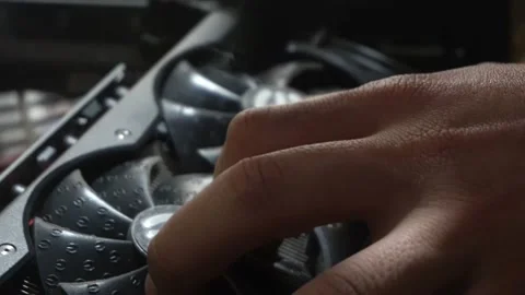 Closeup cleaning the fans of an EVGA graphics card with an electric blower and 库存影片 167245310