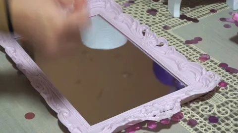 Closeup cleaning a pink tray with a mirror using a napkin Stock Footage 155283392