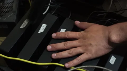 Closeup cleaning several hard drives with an electric blower in a cryptocurrency Video stock 167245052