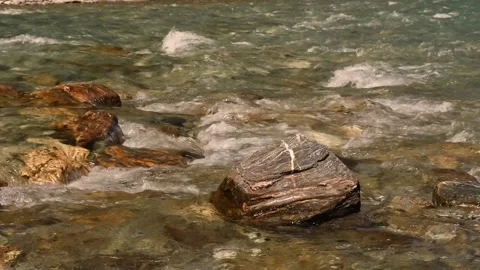 Closeup of a clear, fast-running stream rushing over bouldery bed, New Zealand. Stock Footage 148448352
