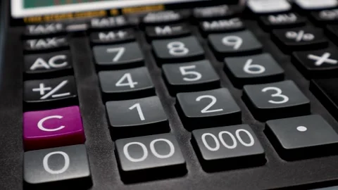 A closeup clip of a calculator with large buttons, rotating on a display stand. Stock Footage 263045253