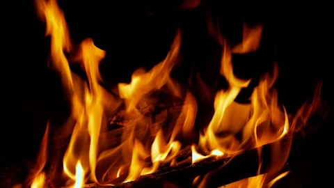 Closeup clip of fire and flickering flames from logs burning in a fireplace Stock Footage 128471854