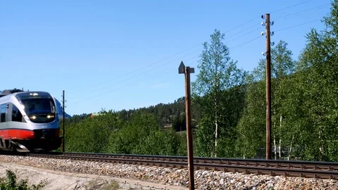 Closeup clip of two red and gray passenger train cars passing by quickly. Stock Footage 116489606