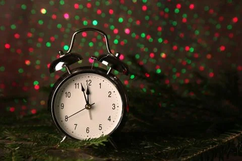 A closeup of a clock with colorful light pattern in the background - countdow Stock Photos