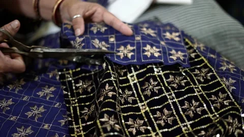 Closeup of cloth cutting, a worker working in textile factory and sewing fabric Stock-Footage 205165310