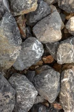 Closeup cobble gray uneven solid rigid base background base pattern Stock Photos