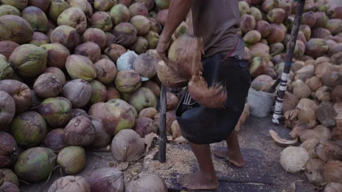 Closeup of a coconut being opened by a man Stock Footage 265580961