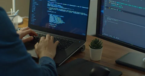 Closeup coding on screen, Man hands coding html and programming on two screen Stock Footage 129449506
