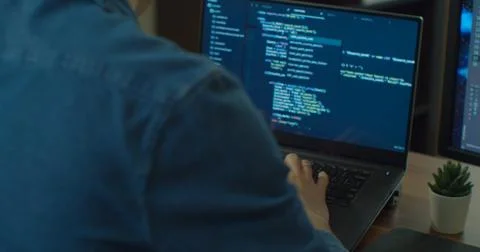 Closeup coding on screen, Man hands coding html and programming on two screen 写真素材