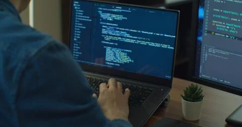 Closeup coding on screen, Man hands coding html and programming on two screen 写真素材