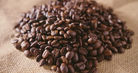 Closeup Of Coffee Beans Falling On Hessian Sack 4K Stock Footage 86084812