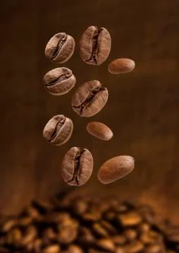 Closeup of coffee beans falling Stock Photos