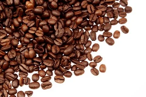 Closeup of coffee beans on plain background Stock Photos