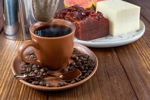 Closeup of coffee beans surrounded by cup, filter cloth and guava sweet and c Stock Photos