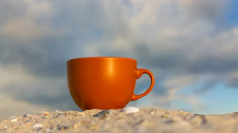 Closeup coffee cup on sandy sea beach time lapse scene Video stock 159280187