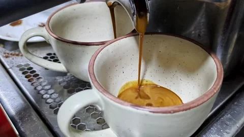 Closeup of coffee machine filtering rich, fresh espresso from freshly groun.. Video stock 313381876