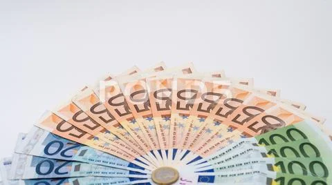 Closeup of a coin one euro with banknotes of different values. Cash money Stock-Fotos