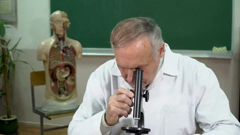 Closeup of college professor adjusting microscope in the classroom Stock Footage 71999116