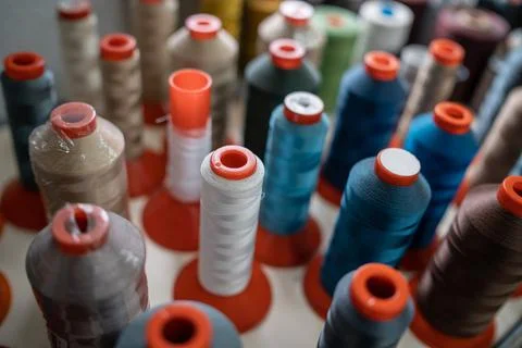 Closeup of color sewing thread set at textile or clothing factory or manufacture Foto stock