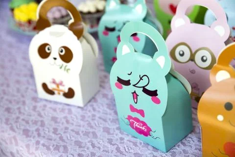A closeup of colorful candy boxes with characters printed on them under the s Stock Photos