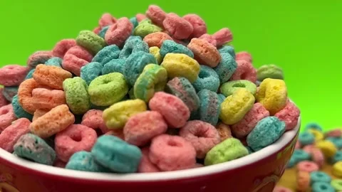Closeup Of Colorful Ring Shaped Breakfast Cereal Piled In Red Bowl Against Stock Footage 348704843